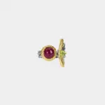 ONDA LENTA two-tone statement earring featuring a round red cabochon gemstone and faceted green gemstone with sculptural gold and silver details.